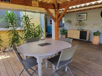 a white table and chairs in a room with plants at A VIGNA VECCHIA chambre d'hôtes in Porto-Vecchio