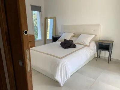 a bedroom with a white bed with a towel on it at Casa Laura in Cervione