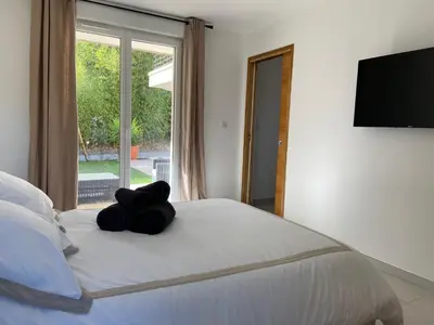 a teddy bear sitting on top of a bed at Casa Laura in Cervione