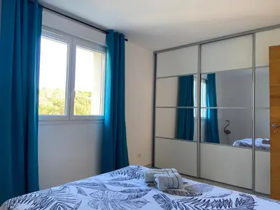 a bedroom with a large mirror and a bed at Casa Laura in Cervione