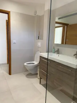 a bathroom with a toilet and a sink and a mirror at Casa Laura in Cervione