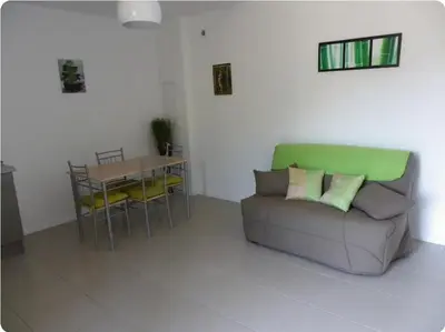 a living room with a couch and a table at Appartement moderne et calme à Sartène en Corse du Sud in Sartène