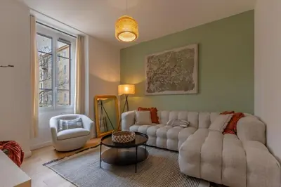 a living room with a couch and a table at Paloa - Hypercentral Close to train station Cozy in Ajaccio