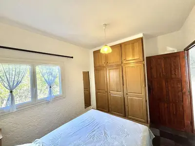 a bedroom with a bed and a large window at Appartement Golfe de Lava in Appietto