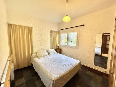a bedroom with a bed and a window at Appartement Golfe de Lava in Appietto