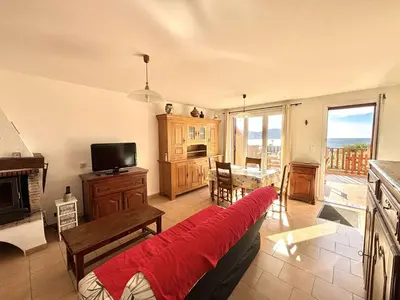 a living room with a couch and a television at Appartement Golfe de Lava in Appietto