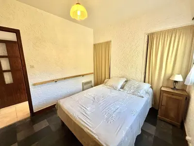 a bedroom with a white bed and a window at Appartement Golfe de Lava in Appietto