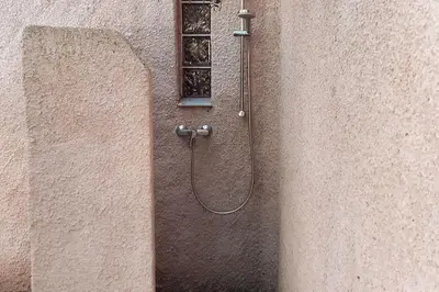 a shower on the side of a building at Petit nid douillet à deux pas de Santa Giulia in Porto-Vecchio