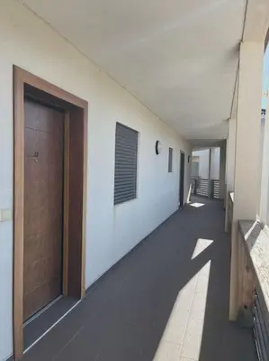 an empty hallway of a building with a door at Appartement fonctionnel 4p avec piscine et vue mer in Porto-Vecchio