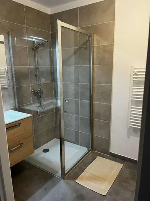 a shower with a glass door in a bathroom at Très beau T2 in Ajaccio