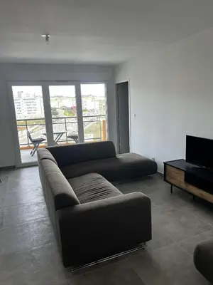 a living room with a couch and a television at Très beau T2 in Ajaccio