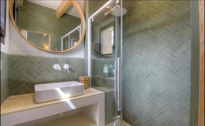a bathroom with a shower with a sink and a mirror at CASA BIANCA 6 personnes Piscine Chauffée in Bonifacio
