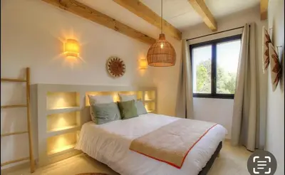 a bedroom with a bed and a window at CASA BIANCA 6 personnes Piscine Chauffée in Bonifacio