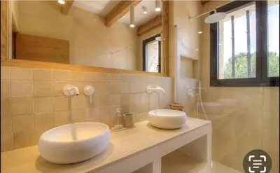 a bathroom with a white sink and a mirror at CASA BIANCA 6 personnes Piscine Chauffée in Bonifacio
