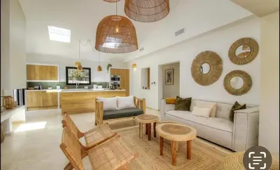 a living room with a couch and a table at CASA BIANCA 6 personnes Piscine Chauffée in Bonifacio