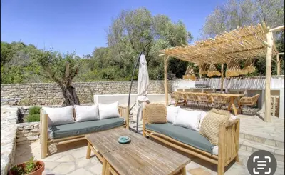 a patio with two couches and a table at CASA BIANCA 6 personnes Piscine Chauffée in Bonifacio