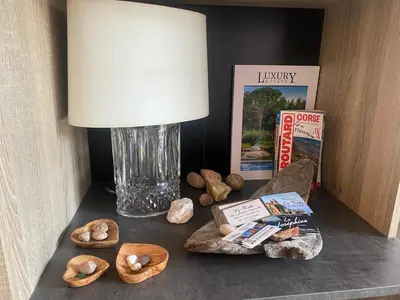 a table with a lamp and some rocks on it at Piana - vue mer et village in Piana