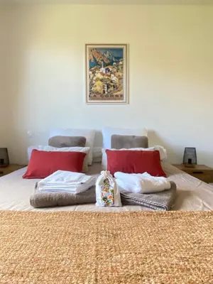 a bedroom with a bed with red pillows at Piana - vue mer et village in Piana