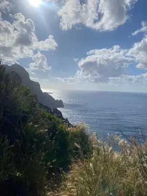 a view of the ocean from a hill with the sun at Piana - vue mer et village in Piana