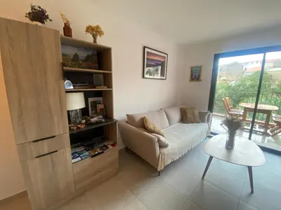 a living room with a couch and a table at Piana - vue mer et village in Piana