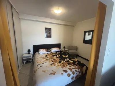 a bedroom with a bed with leaves on it at Appartement F2 dessous de villa in Olmeta-di-Tuda
