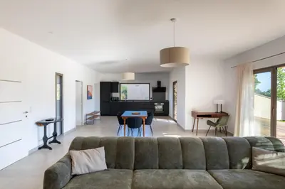 a living room with a couch and a table at Villa avec piscine in Ghisonaccia