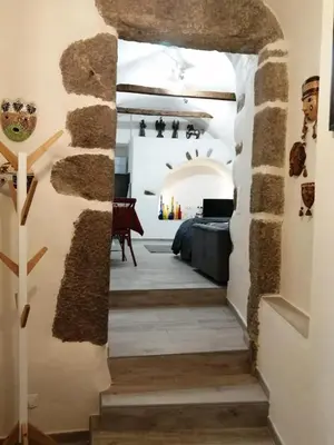 a hallway in a house with a stone wall at Studio neuf à 15mn de la mer in Occhiatana
