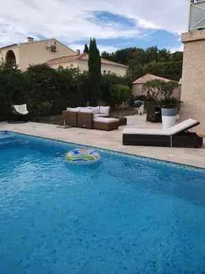 a swimming pool with a toy in the water at Maison à Saint-Florent avec piscine privée in Oletta