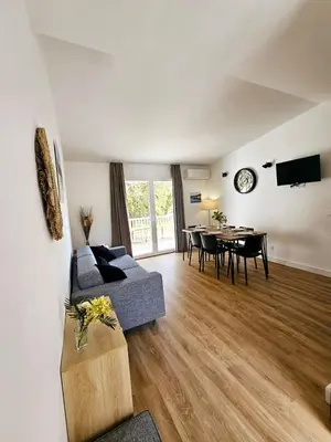 a living room with a couch and a table at Très bel appartement T3 dans résidence hotellière 