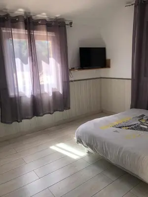 a bedroom with a bed and a tv on the wall at Chez Aldo in Ajaccio