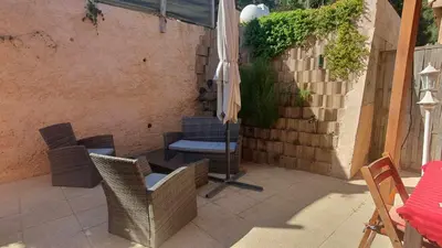 a patio with a table and chairs and an umbrella at Chez Aldo in Ajaccio