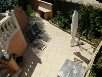 a model of a patio with a umbrella and chairs at Chez Aldo in Ajaccio
