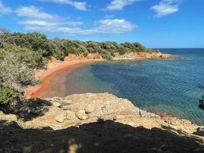 a beach with a bunch of rocks and water at Villa A CASA DI LO in Lecci