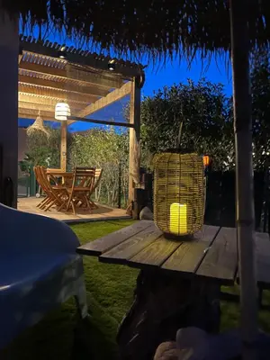 a picnic table with a lamp on it in a yard at Villa A CASA DI LO in Lecci