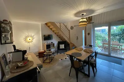 a living room with a table and a dining room at Villa A CASA DI LO in Lecci