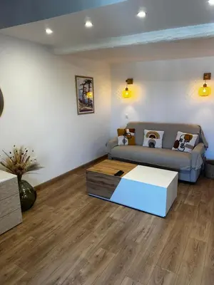 a living room with a bed and a couch at Appartement U Diu Grossu in Bonifacio