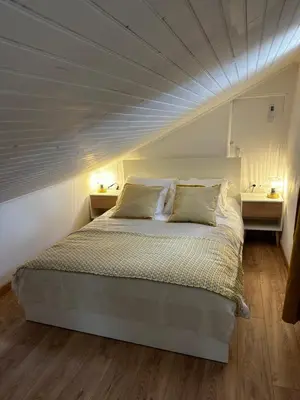 a bedroom with a bed with a white ceiling at Appartement U Diu Grossu in Bonifacio