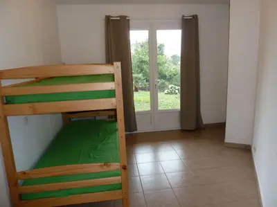 a bunk bed in a room with a window at T3 en rdj pour 6 pers dans résidence avec piscine in Propriano
