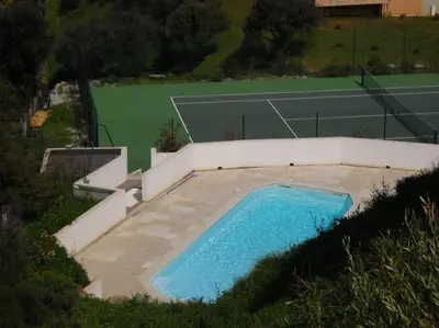 an overhead view of a swimming pool and a tennis court at T3 en rdj pour 6 pers dans résidence avec piscine in Propriano