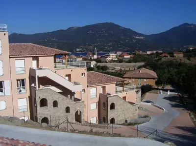 a view of a building with a parking lot at T3 en rdj pour 6 pers dans résidence avec piscine in Propriano