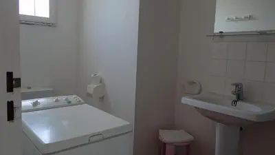 a white bathroom with a sink and a toilet at Residence Funtanella in Sagone