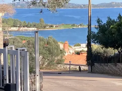 a view of a lake from a gate at Studio à 5 minutes à pied du centre ville de Porto Vecchio in Porto-Vecchio