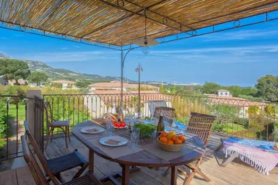 a table with a bowl of fruit on a patio at Beautiful Apartment 