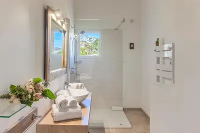 a white bathroom with a sink and a mirror at Beautiful Apartment 