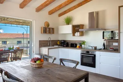 a kitchen with a wooden table and a dining room at Beautiful Apartment 