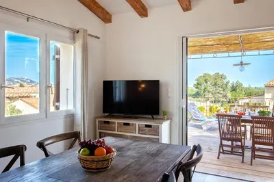 a dining room with a table and a television at Beautiful Apartment 