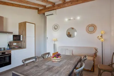 a kitchen and living room with a wooden table and chairs at Beautiful Apartment 