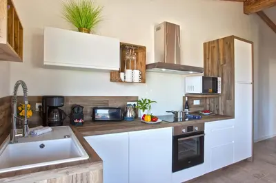 a kitchen with white cabinets and a sink at Beautiful Apartment 