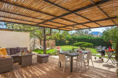an outdoor patio with a wooden pergola at Villa 