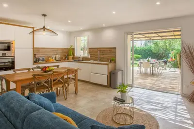 a kitchen and a living room with a blue couch at Villa 
